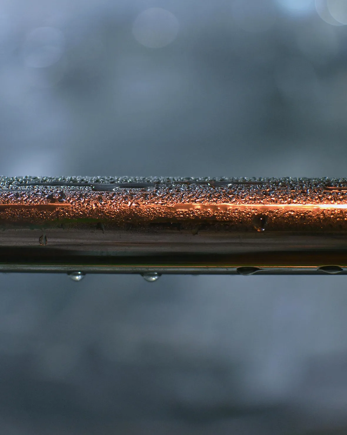 Water dripping from a leaking metal pipe